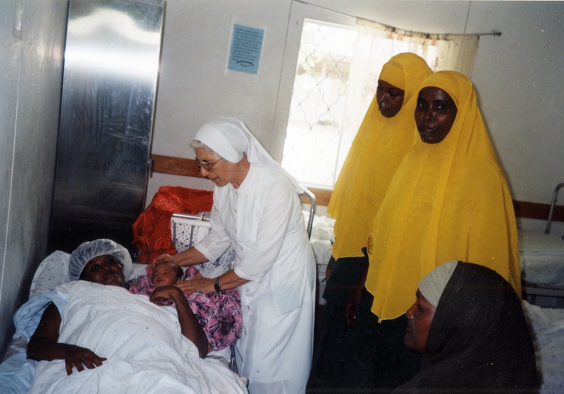 Consolata sr attends to a patient with nursing students