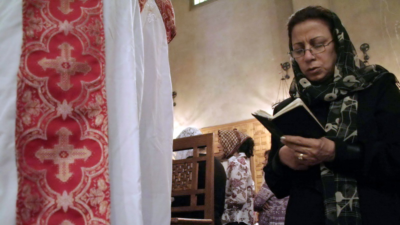 An Egyptian Coptic woman praying during a church service in Cairo.