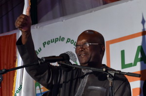 Roch Marc Christian Kabore waves to supporters at party headquarter in Ouagadougou on December 1, 2015 after winning Burkina Faso's presidential election, official results showed, after a year of turmoil that saw the west African country's former leader deposed and the military try to seize power in a coup. AFP PHOTO / ISSOUF SANOGO / AFP / ISSOUF SANOGO