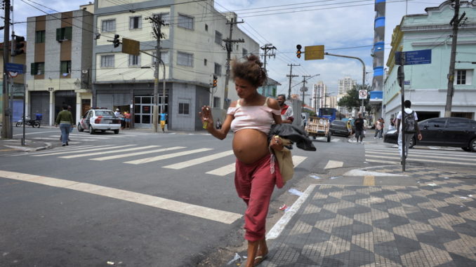 TO GO WITH AFP STORY BY ANELLA RETA A pregnant drug addicts walks along a street at "Crackolandia," a place where drug users addicted to crack cocaine have been gathering for the past seven years to smoke their freebase in downtown Sao Paulo, Brazil, on December 9, 2009. In rags and bare feet, they walk through Sao Paulo's dilapidated city center like ghosts. Some beg for change that goes straight to purchasing the drug that has wasted away their bodies as surely as it has their personalities, their futures and their sense of self-worth. AFP PHOTO/Mauricio LIMA / AFP PHOTO / MAURICIO LIMA